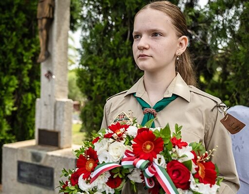 grief-care-girl-scout-holding-wreath-cemetery-crucifix